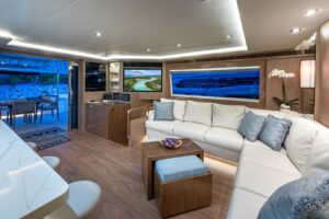 2023 Horizon PC60 pilothouse yacht helm station with dual helm seats, Garmin multifunction displays, and forward visibilit...