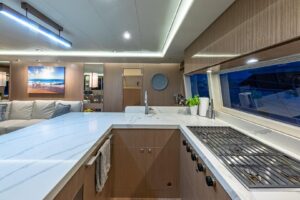 2023 Horizon PC60 motor yacht helm station with dual Garmin displays, leather helm chair, and forward salon visibility thr...