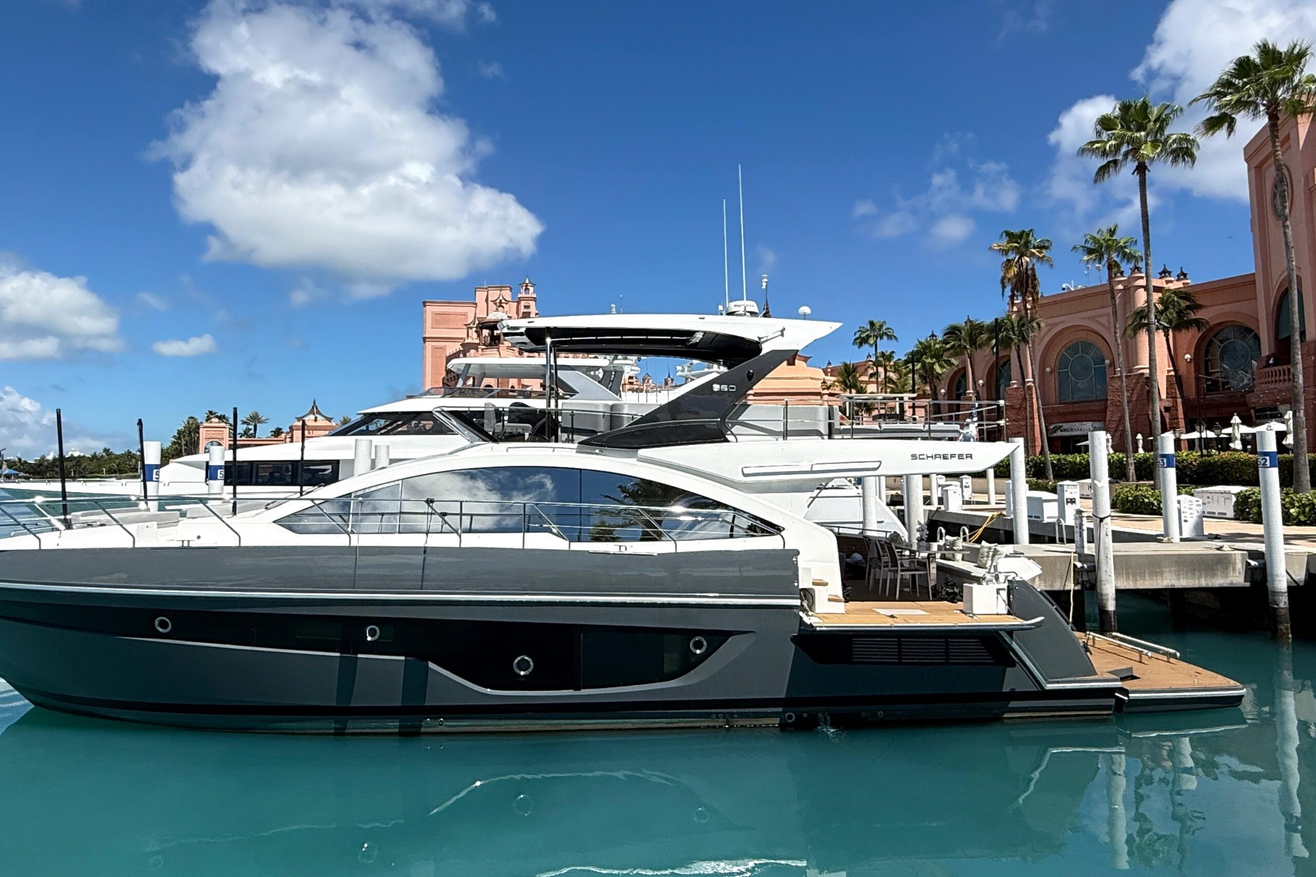 2023 Schaefer 660 motor yacht profile showing full 66-foot length with hardtop and twin outboard engines at Deerfield Beach.