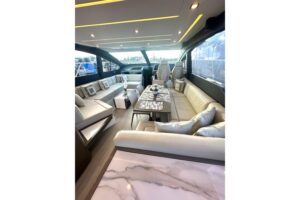 Schaefer 660 cabin cruiser helm station with dual Garmin displays and leather helm seating in Deerfield Beach, Florida.