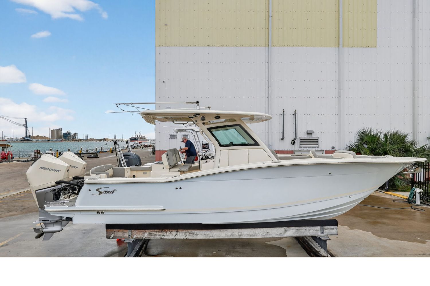 2023 Scout 305 LXF center console fishing boat with twin outboard engines, bow seating, and hardtop in Stuart, Florida.