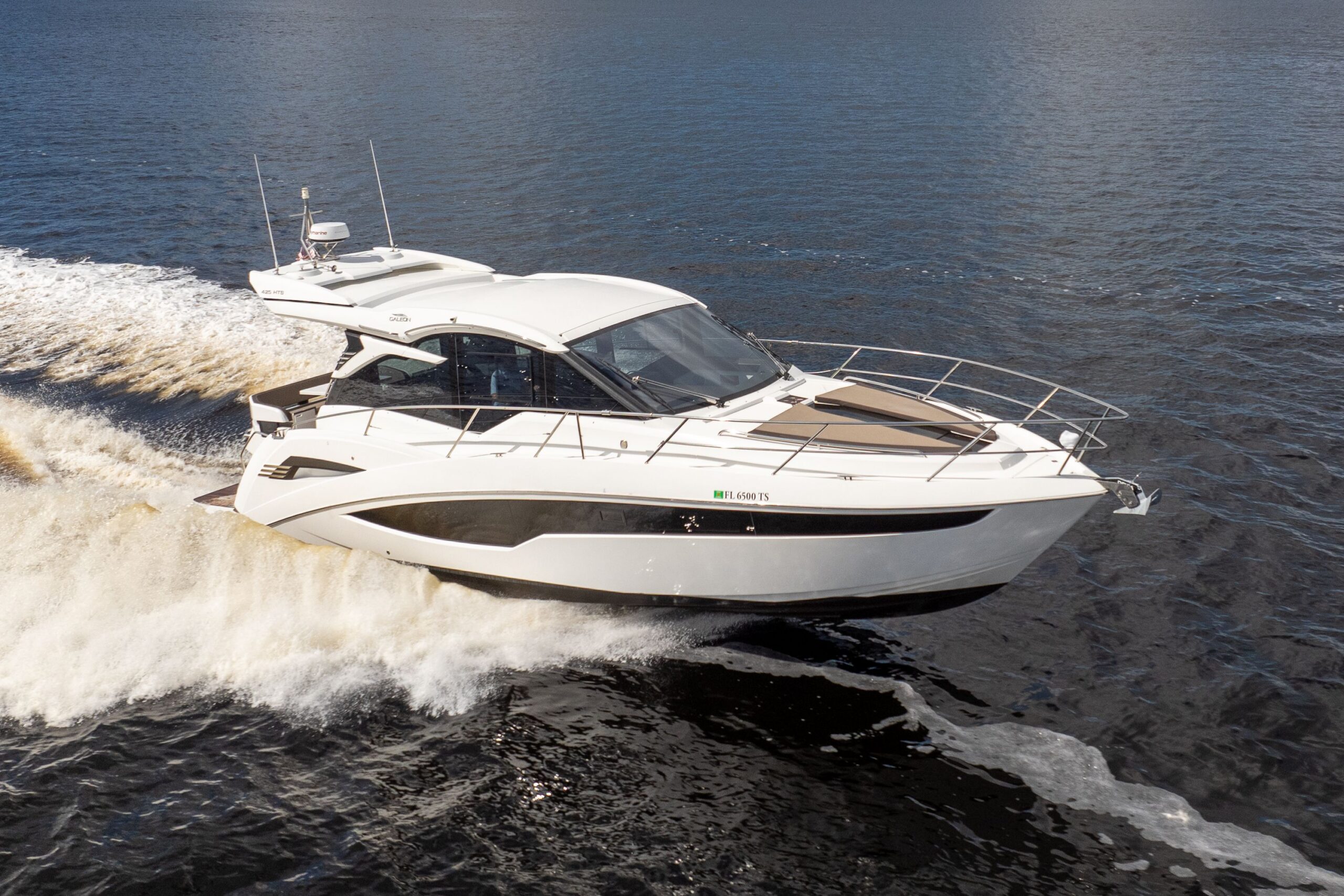 2024 Galeon 425 HTS 42-foot hardtop cruiser with dual helm stations and integrated tower, moored in Fort Myers showing sta...