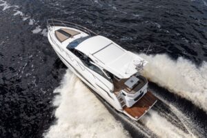 Galeon 425 HTS helm station with dual Garmin displays, leather helm seat, and hardtop overhead in the pilothouse.