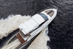 Galeon 425 HTS helm station with dual Garmin displays, leather helm seat, and forward visibility through hardtop windscreen.