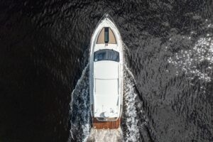 Galeon 425 HTS helm station with dual Garmin displays, leather helm seat, and forward visibility through hardtop-protected...