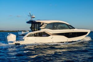 2024 Galeon 435 GTO helm station with dual Garmin displays, leather helm seat, and forward windscreen view of cabin entrance.