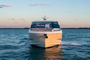 Galeon 435 GTO helm station with dual Garmin displays, leather helm seating, and forward windscreen view of cabin entrance.