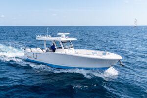 2024 Robalo R360 center console with triple outboard engines shown in starboard profile view at dock in North Miami, Florida.