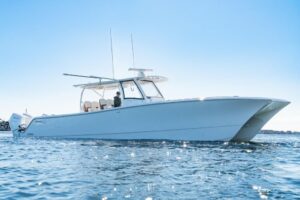 2025 Front Runner 43 catamaran starboard profile showing dual hulls, hardtop, and helm station under way.