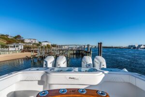 Front Runner 43 catamaran twin helm station with dual Garmin displays and stainless steel wheel steering.