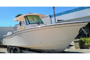 2025 Grady-White Canyon 326 center console fishing boat with hardtop and outboard engines moored in Riviera Beach, Florida.