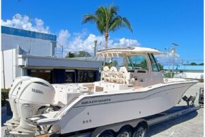 Bow seating and anchor locker on 2025 Grady-White Canyon 326 center console with forward cushioned seating and stainless s...