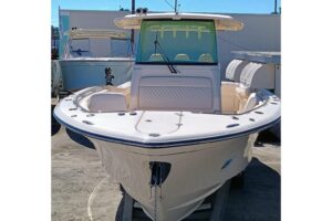 Grady-White Canyon 326 helm station with dual Garmin displays, center console steering, and forward visibility through win...