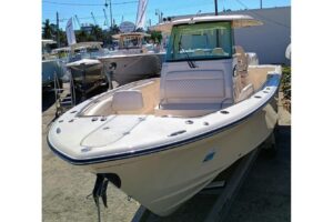Grady-White Canyon 326 helm station with dual Garmin displays, steering wheel, and center console controls in Riviera Beac...