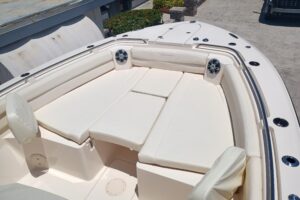 Grady-White Canyon 326 center console helm station with dual Garmin displays, steering wheel, and throttle controls.