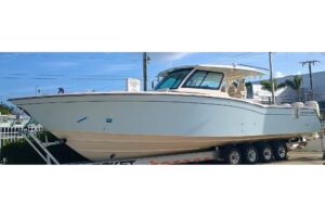 2025 Grady-White Canyon 456 center console fishing yacht with twin outboard engines, hardtop, and full helm station photog...