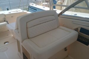 Grady-White Canyon 456 helm station with dual Garmin displays, center console steering, and forward visibility through win...
