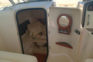 2025 Grady-White Canyon 456 helm station with dual Garmin displays, center console steering, and forward visibility throug...