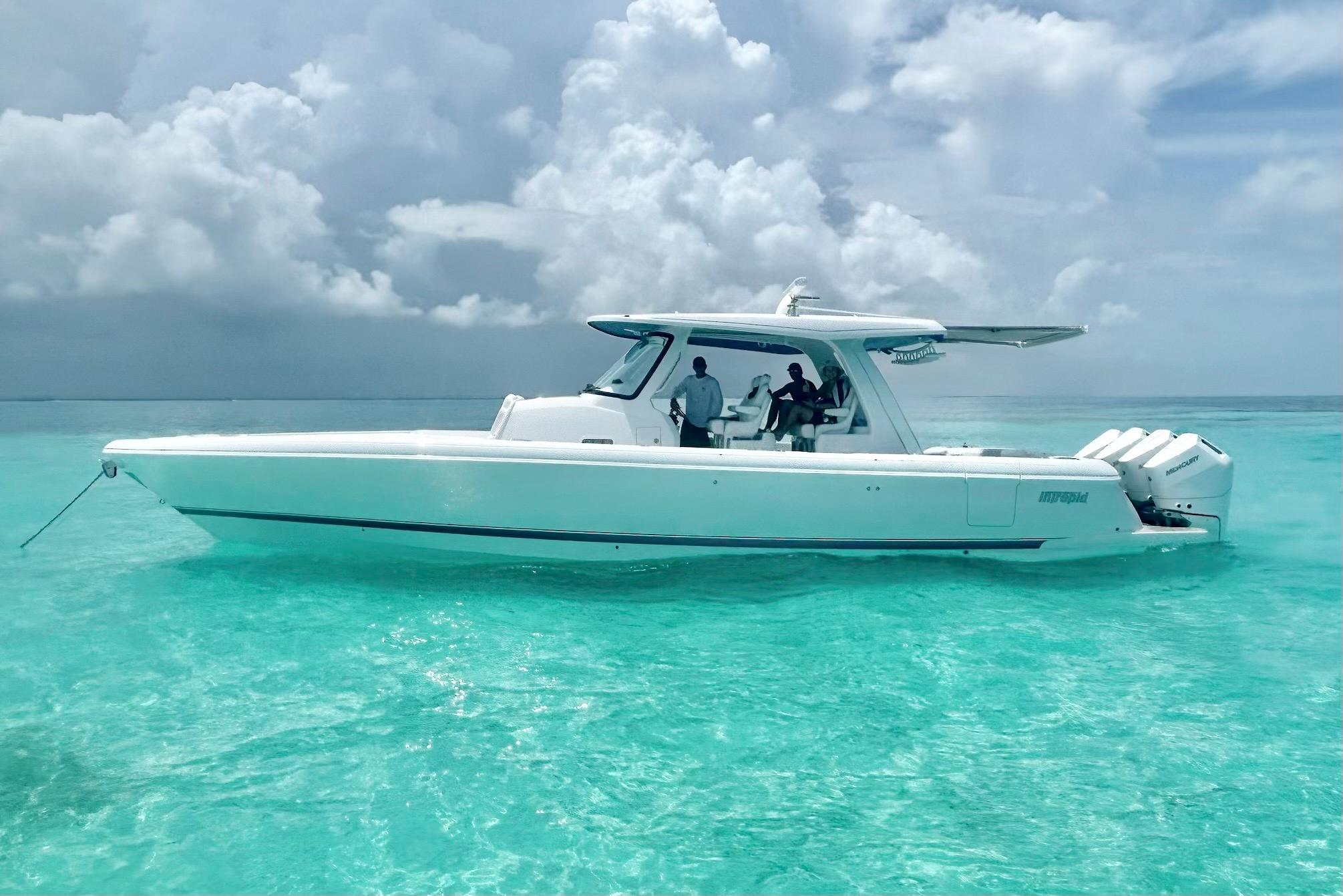 2025 Intrepid 43 Nomad SE center console yacht profile with hardtop and tower station moored in Miami Beach.