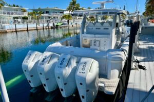 Intrepid 43 Nomad SE center console helm station with dual Garmin displays, steering wheel, and forward visibility through...