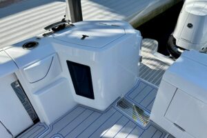 Intrepid 43 Nomad SE helm station with dual Garmin displays, leather helm seat, and center console steering wheel in moder...