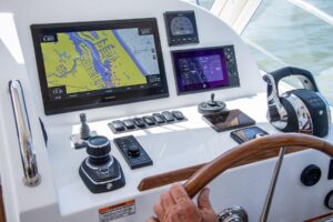 2025 MJM 35 center console helm station with dual Garmin displays, steering wheel, and forward visibility through windscreen.