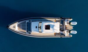 2025 Protector 380 Targa helm station with dual Garmin displays, center console steering, and forward visibility through h...