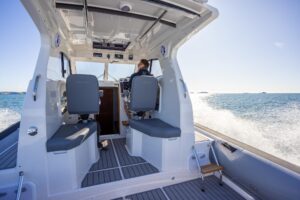 Protector 380 Targa helm station with dual Garmin displays, center console steering, and targa hardtop overhead.