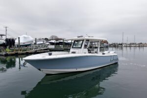 Bow view of 2025 Robalo R300 center console with forward seating and windshield.