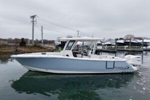 Bow seating and forward console of 2025 Robalo R300 center console with integrated helm station and windshield.