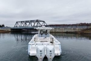 Robalo R300 center console helm station with dual Garmin displays, steering wheel, and forward visibility over bow.