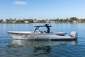 Wajer 38s helm station with dual Garmin displays, leather helm seating, and stainless steel steering wheel in modern pilot...