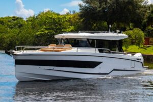 2025 Wellcraft 38 Explorer white hull with hardtop and outboard engines photographed from port side profile in Holiday, Fl...