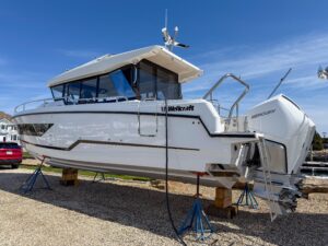 Wellcraft 38 Explorer bow seating area with forward cabin entry and windshield protection.