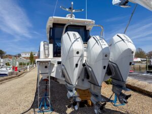 Wellcraft 38 Explorer helm station with dual Garmin displays, center console steering, and forward visibility through wind...
