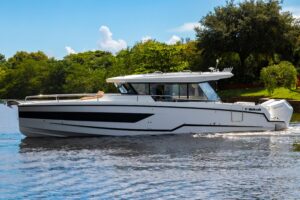 Wellcraft 38 Explorer helm station with dual Garmin displays, center console steering, and forward visibility through wind...