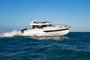 Wellcraft 38 Explorer helm station with dual Garmin displays, center console steering, and forward visibility through wind...