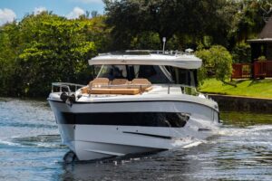 Wellcraft 38 Explorer helm station with dual Garmin displays, center console steering, and forward windshield view.