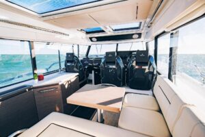 Wellcraft 38 Explorer helm station with dual Garmin displays, center console steering, and forward visibility through wind...