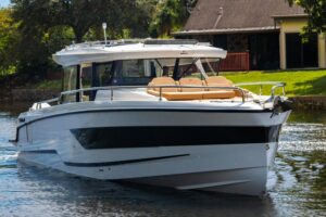 Wellcraft 38 Explorer helm station with dual Garmin displays, center console steering, and forward visibility through wind...
