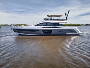 Azimut S7 70-foot luxury yacht helm station with dual helm seats, Garmin multifunction displays, and forward salon visibil...