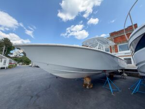 Bow seating area of 2026 Jupiter 32 center console with forward-facing cushioned seats and windscreen.