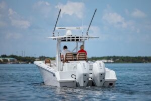 Helm station of 2026 Jupiter 32 center console with dual Garmin displays, steering wheel, and forward visibility over bow.