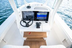 Helm station of 2026 Jupiter 32 with dual Garmin displays, center console steering, and forward visibility through windscr...