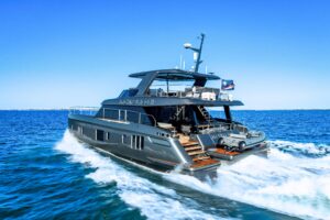 Sunreef 60 Power catamaran helm station with dual Garmin displays, leather helm seating, and forward salon visibility thro...