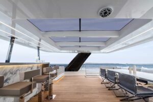 Sunreef 60 Power catamaran bow seating area with forward lounge and cushioned sunpad overlooking the water.