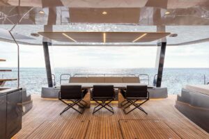 Sunreef 60 Power catamaran salon with expansive windows, contemporary furnishings, and open-plan living space.