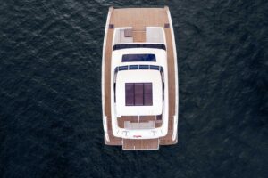Sunreef 70 Power catamaran bow with dual hulls and forward seating area viewed from starboard side.