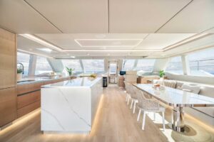 Sunreef 70 Power catamaran salon with expansive windows, modern seating, and open-plan living area.