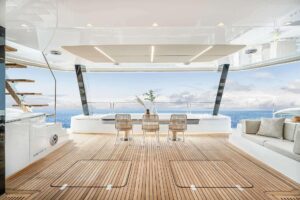 2026 Sunreef 70 Sunreef Power catamaran main salon with contemporary furnishings and large windows overlooking the water.